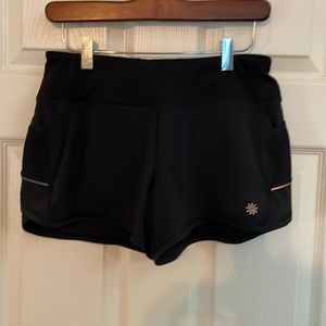 Athleta 4” shorts. Flat waist band. Size XS. Black. Lots of pockets. EUC